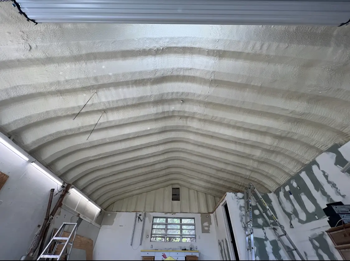 Spray polyurethane foam applied to the underside of a metal roof deck in Wellsville
